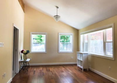 Room is filled with light and high ceiling and wood floors add to the aesthetics