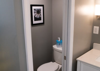 Toilet Room in new Master Bedroom with Exhaust Fan and Pocket Door